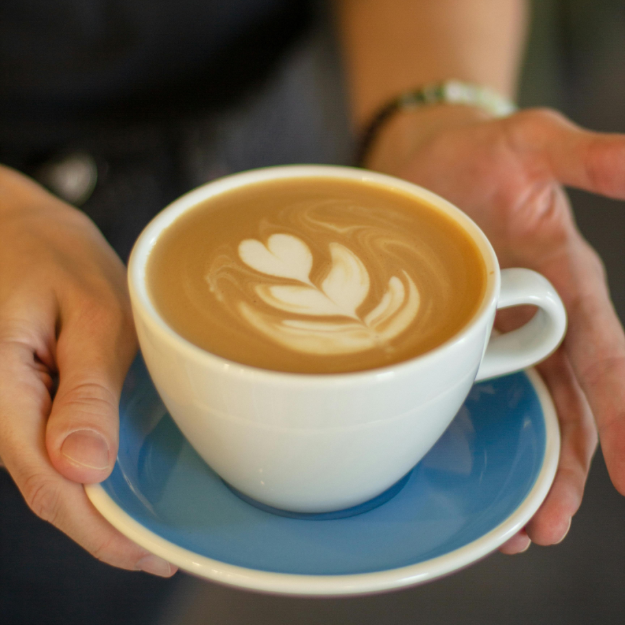 offering a warm mug with a cream heart